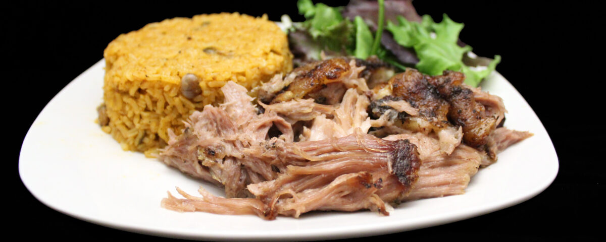 Plato de Pernil — Puerto Rican slow-roasted pulled pork with arroz con gandules and mixed greens salad at Phoenix Coqui, Phoenix AZ.