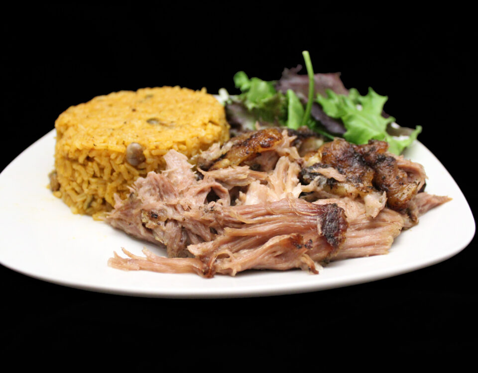 Plato de Pernil — Puerto Rican slow-roasted pulled pork with arroz con gandules and mixed greens salad at Phoenix Coqui, Phoenix AZ.